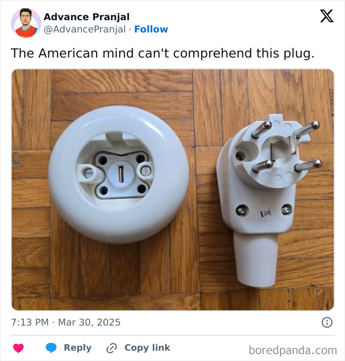 Unusual three-prong electrical plug and socket on a wooden floor, illustrating confusing American mind concept.