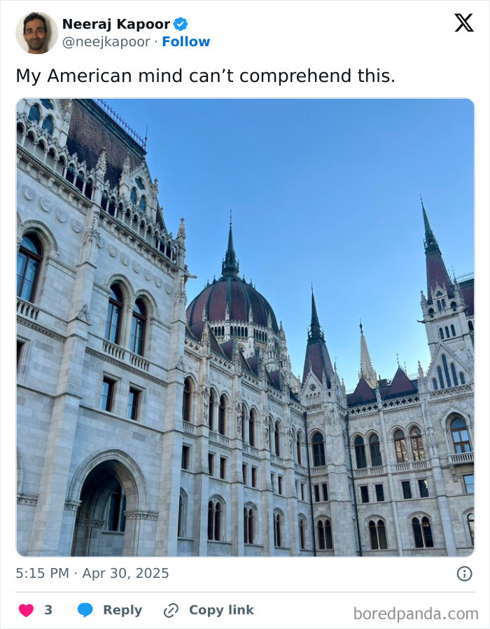 Ornate European Gothic architecture with spires and a large dome under a clear blue sky, confusing American minds.
