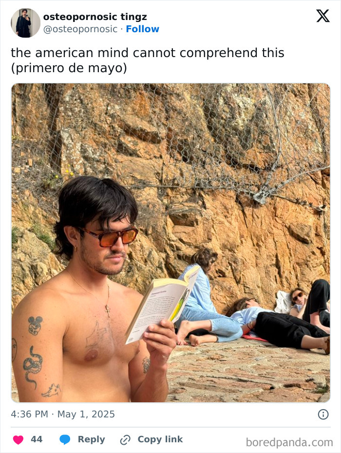 Young man with tattoos and sunglasses reading a book near rocky cliff, confusing American mind concept illustrated.