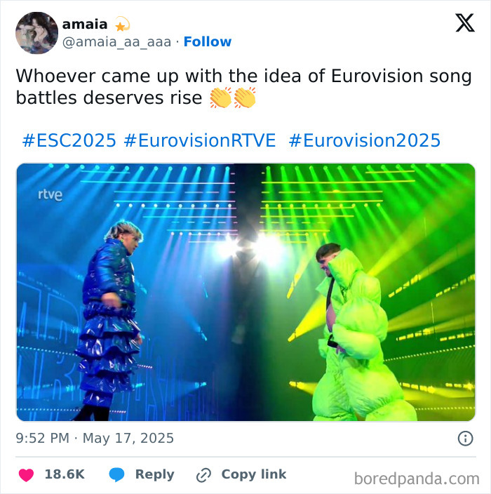 Two performers in colorful futuristic outfits face off on stage with bright blue and green lighting during Eurovision 2025.