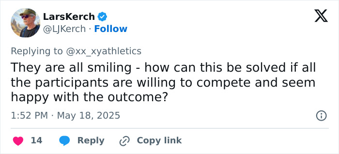 High school girl standing defiantly on first-place podium after losing to trans athlete at sports event.