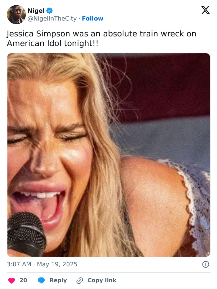 Jessica Simpson singing passionately into a microphone during her first live TV performance in 15 years.