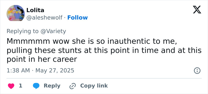 A social media reply criticizing Jennifer Lopez for her inauthentic actions related to a lesbian kiss at the AMAs.