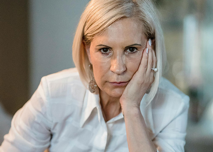 Woman looking upset and frustrated, representing a horrible stepmom left furious after being blocked and confronted