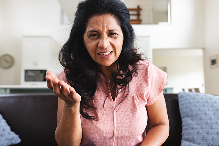 Woman in pink shirt looking upset and confused, expressing frustration about having a say in her own sweet 16 celebration. Woman in pink shirt looking upset and confused, expressing frustration about having a say in her own sweet 16 celebration.