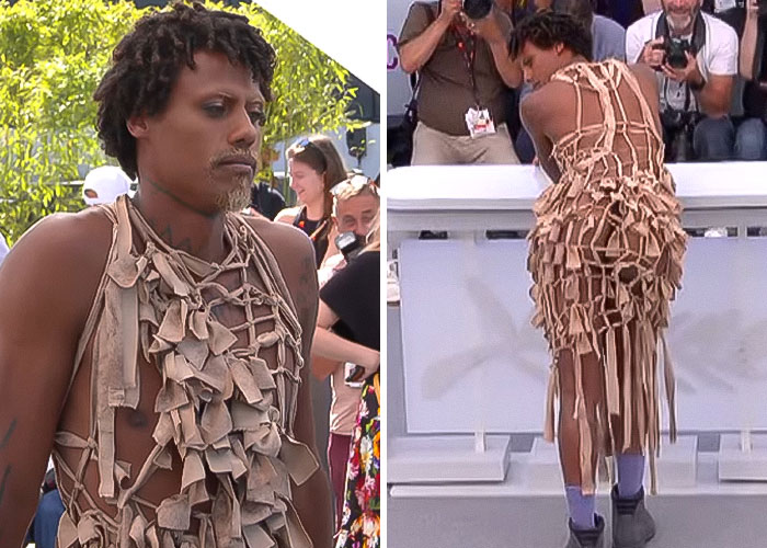 Star at Cannes revealing backside in a unique dress, breaking dress code to applause from photographers and crowd.