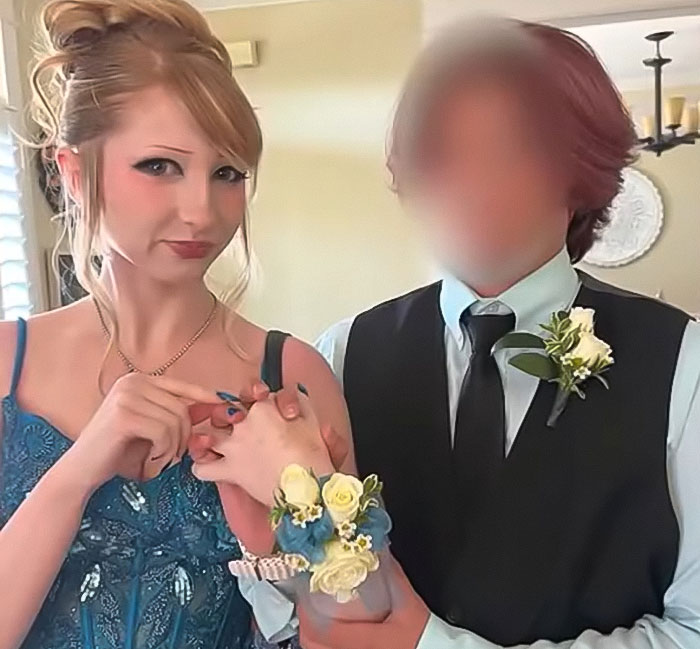 Teen girl in blue prom dress with corsage holding hands with a young person in vest, linked to Christian school expulsion debate.