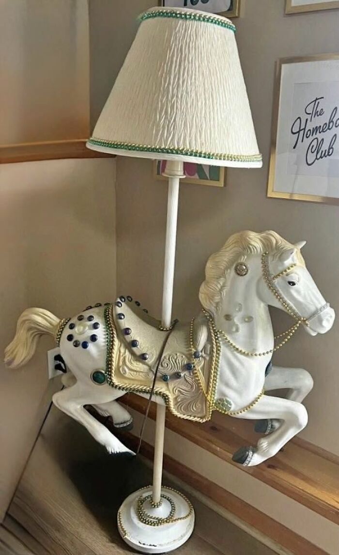 White vintage horse lamp with decorative jewels and a beige textured lampshade in a cozy corner setting, thrifted find.