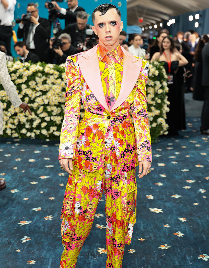Person wearing bright floral suit with pink lapels at an event, showcasing bold style among biggest fashion fails Met Gala 2025.