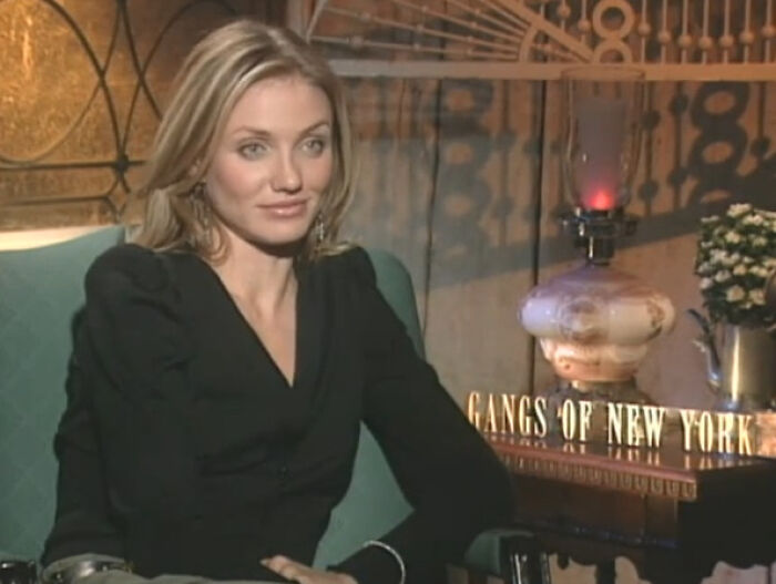 Actress seated in an interview setting, discussing miscast actors and their impact on movies in a studio environment.
