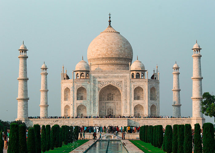 Taj Mahal with crowds showcasing cultural heritage and diverse experiences of living in home countries worldwide.