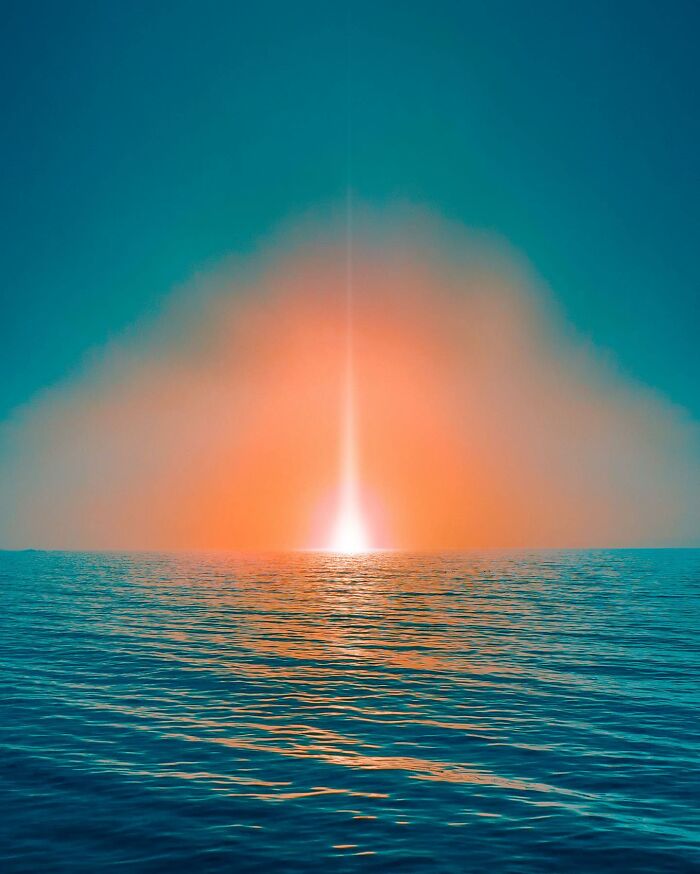 Surreal photo edit showing a glowing light beam rising from the ocean during a colorful sunset visual lies artwork.
