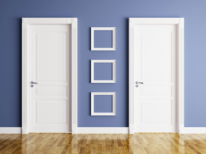 Two closed white doors with empty picture frames on a blue wall, symbolizing weird parent rules and choices.