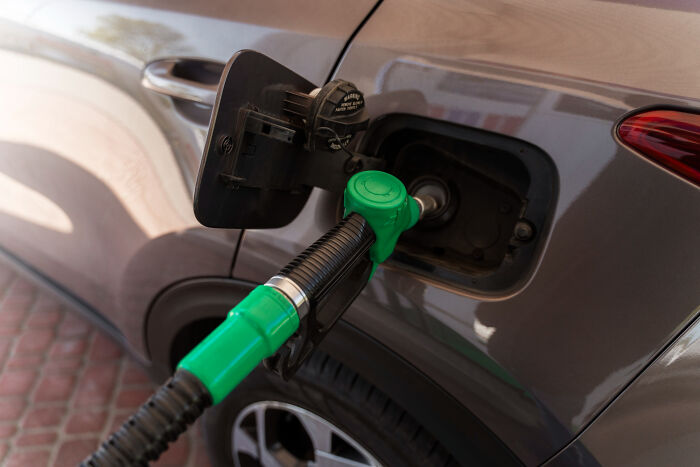 Car being refueled with a green gas pump nozzle highlighting casual things that can actually be deadly risks.