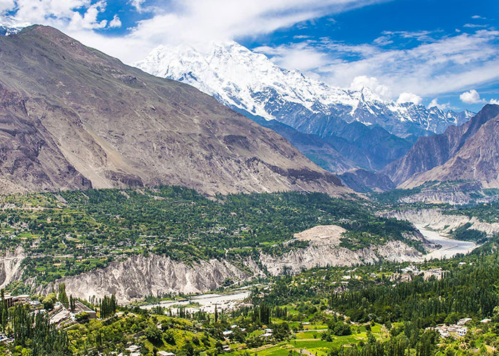 Scenic mountainous valley with lush greenery, illustrating diverse landscapes discussed by people living in their home countries.