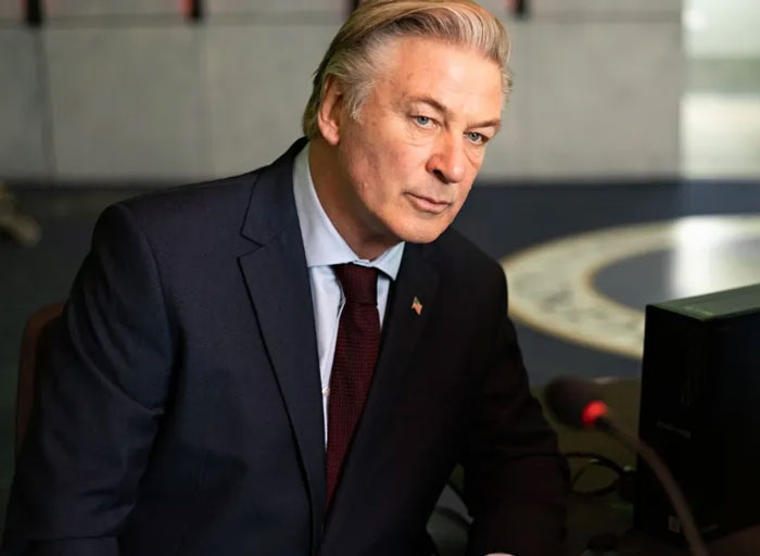 A man in a suit and tie focused during a formal event, representing celebrity encounters that went well or badly.