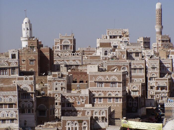 Ancient cityscape of intricately designed buildings and mosques, a stunning UNESCO treasure site under clear blue sky.