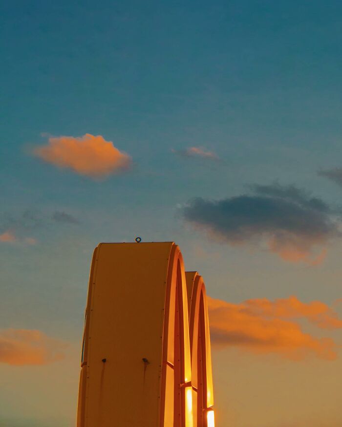 Golden arches glowing at sunset against a colorful sky, showcasing creative photo edits that make you question reality.
