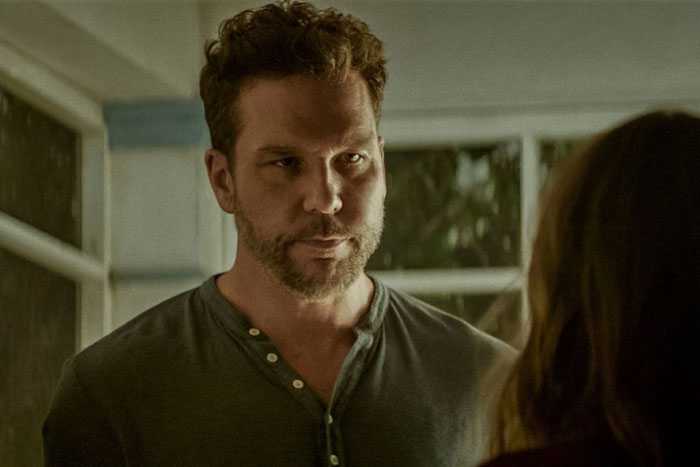 Man with beard and casual shirt engaging in a tense celebrity encounter scene indoors for celebrity encounters SEO topic.