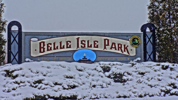 Belle Isle Park entrance sign covered in snow, representing a once popular tourist destination now fallen into oblivion.