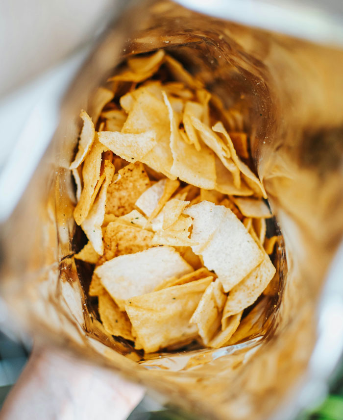 Close-up of a partially full chip bag inside, illustrating one weird rule your parents had around snacks.