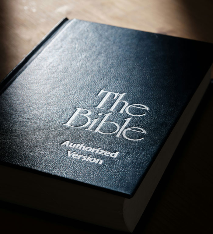Close-up of a Bible on a wooden surface symbolizing secrets a spouse might keep until after marriage.
