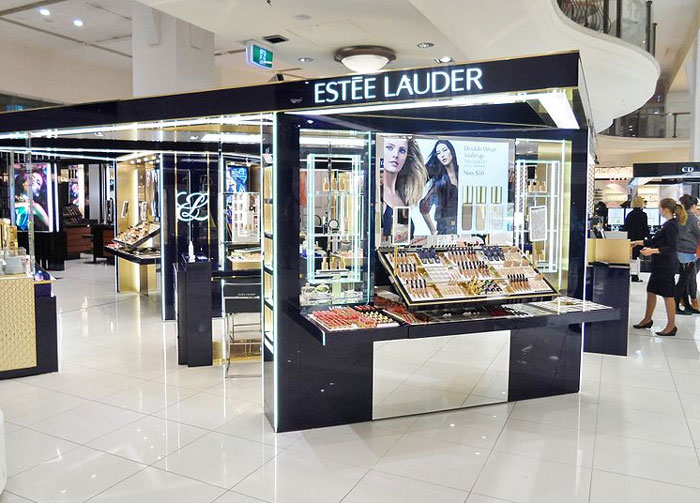 Estée Lauder cosmetics counter in a mall setting illustrating former employees revealing disturbing workplace secrets.