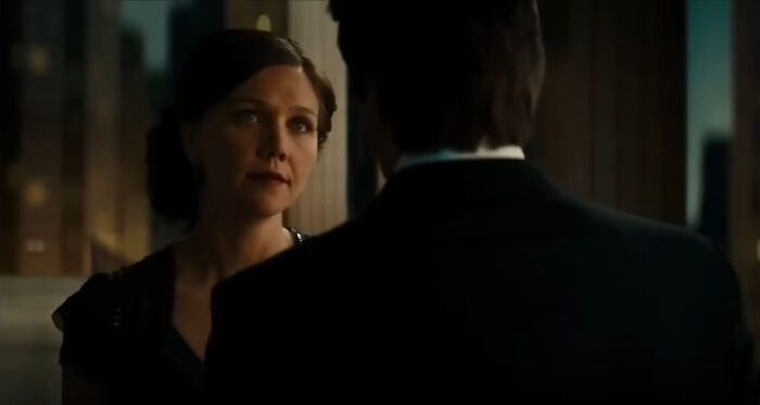 A woman and a man in a dimly lit room illustrating miscast actors in movies affecting film reception.