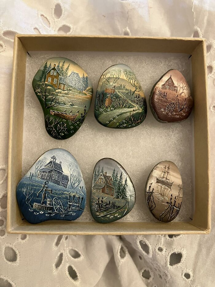 Set of six hand-painted thrifted stones featuring houses, boats, and rural scenes in a vintage style.