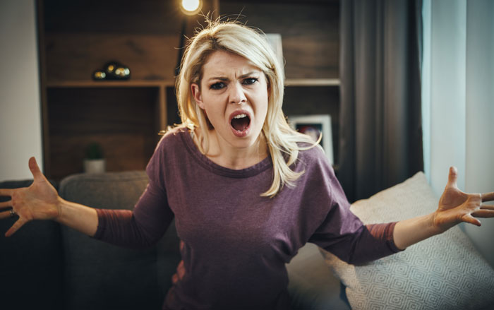 Angry woman in a purple shirt expressing frustration about a roommate accused of tempting a teen and stealing alcohol. Angry woman in a purple shirt expressing frustration about a roommate accused of tempting a teen and stealing alcohol.