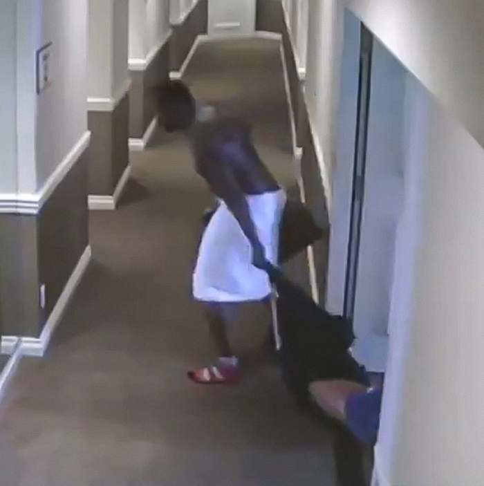Man in hallway dragging another person by clothing, related to Diddy trial jury shocked by graphic freak off party photos. Man in hallway dragging another person by clothing, related to Diddy trial jury shocked by graphic freak off party photos.