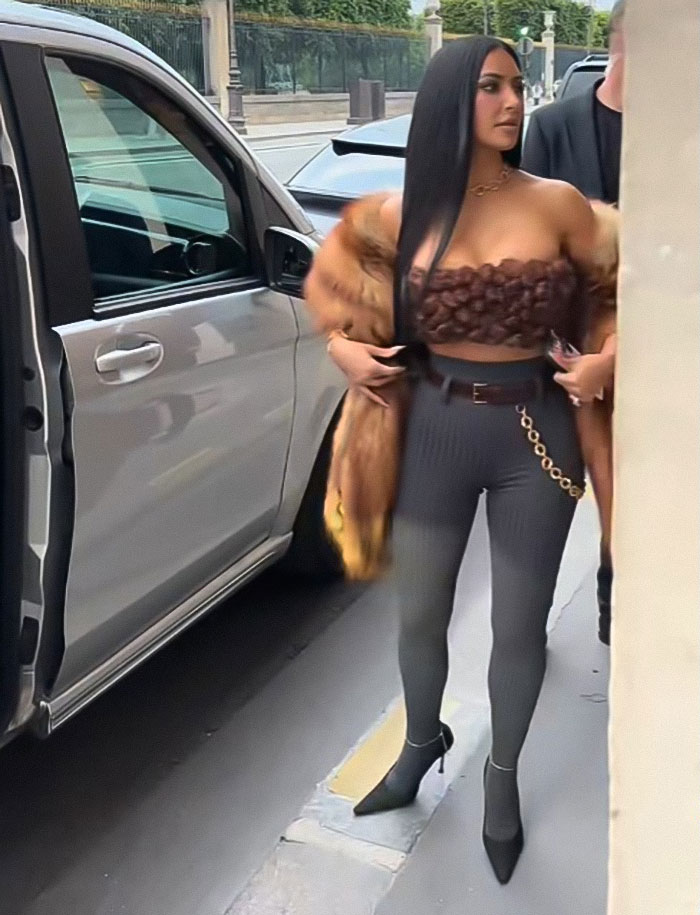 Woman in stylish outfit standing near an open car door during Lauren S&aacute;nchez bachelorette party with Katy Perry and Kim K.