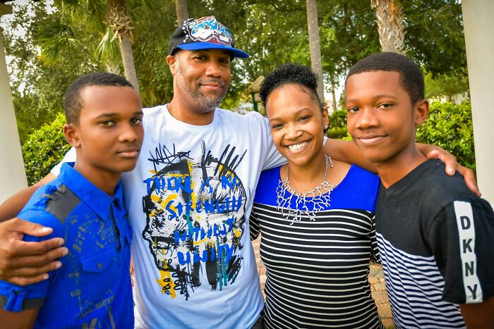 Family of four smiling outdoors, illustrating mind-blowing cultural differences that shape how people see the world.