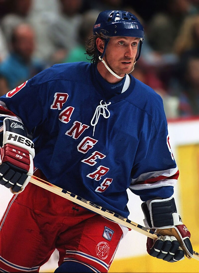 Hockey player in Rangers uniform focused on the game, illustrating celebrity encounters that went well or badly.