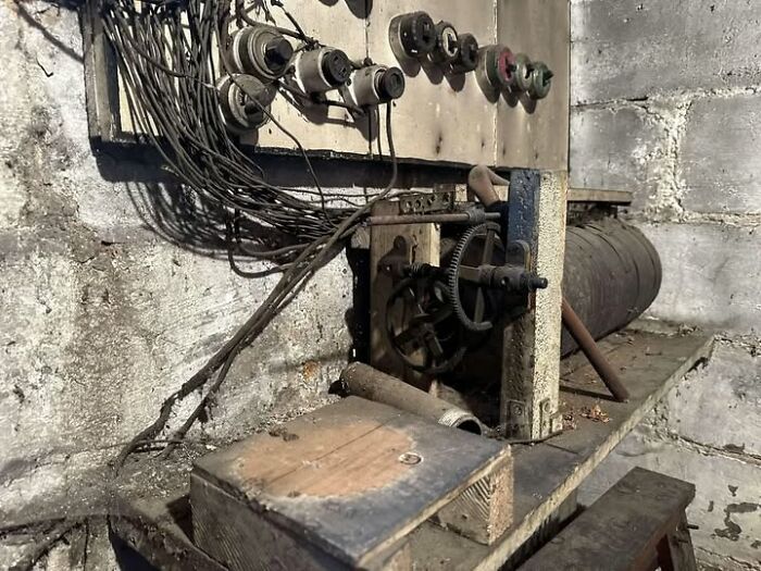 Old dusty electrical wiring and switches on a wall in a home with a hidden and forgotten past setting.