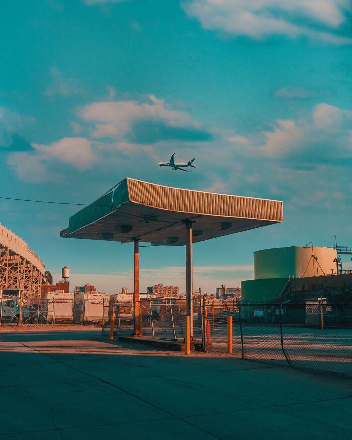 Surreal photo edit of a gas station canopy floating in an urban setting, showcasing creative photo edits that question reality.