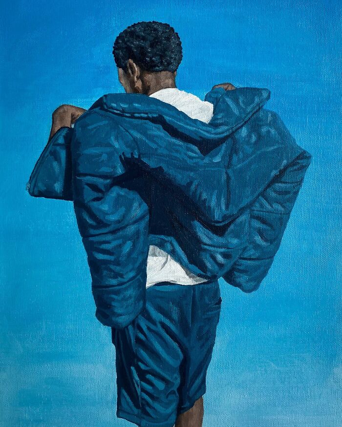 Person wearing a blue jacket and shorts against a blue background, exploring colours, space, and identity in painting.