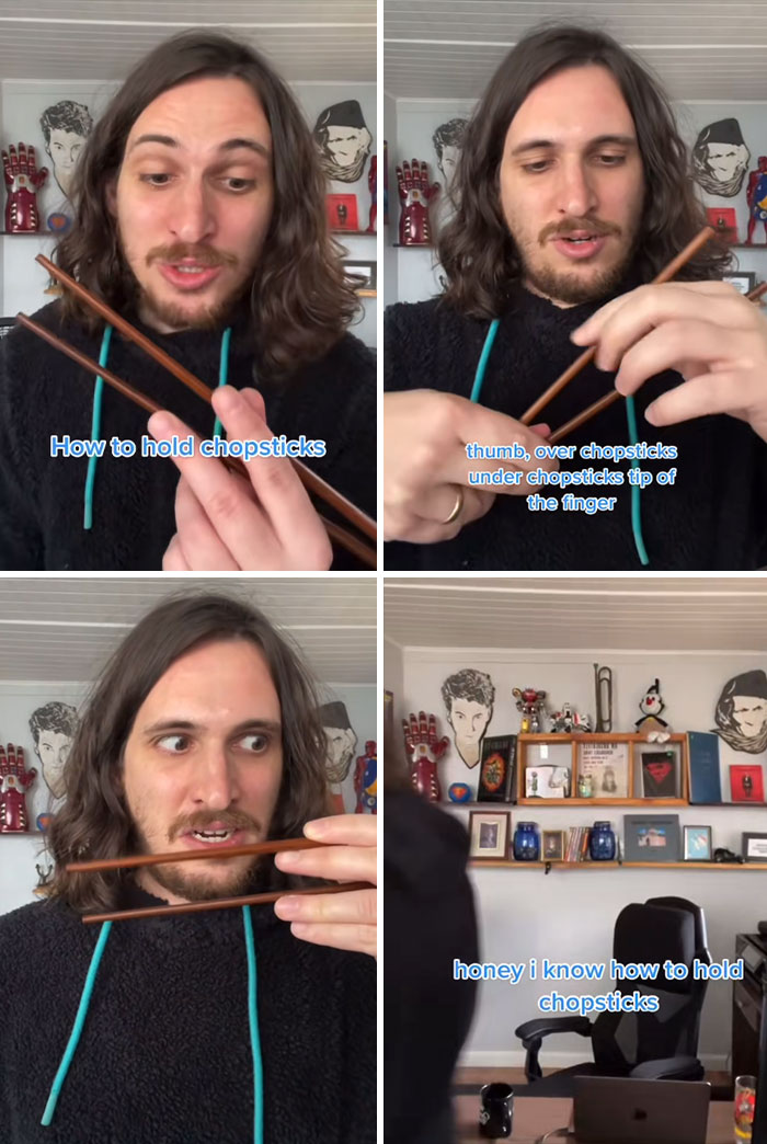 Man with long hair demonstrating how to hold chopsticks correctly in a casual home setting with decorated background.