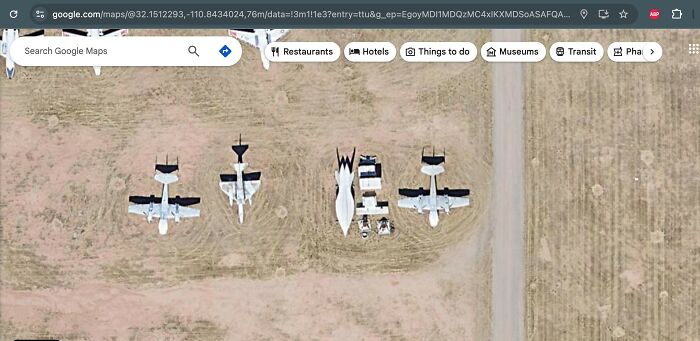 Aerial view of unusual airplane shapes and objects found on Google Earth in a desert area, sparking curiosity.
