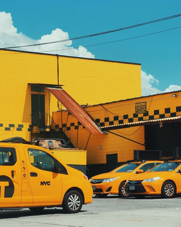 Yellow NYC taxis parked near a vibrant yellow building under blue sky in a creative photo edit showcasing good visual lies.