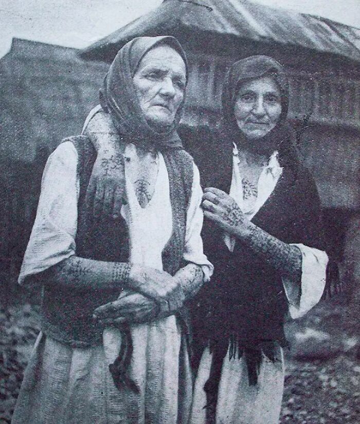 Two elderly women with traditional headscarves and hand tattoos, showing the side of history rarely seen in textbooks.