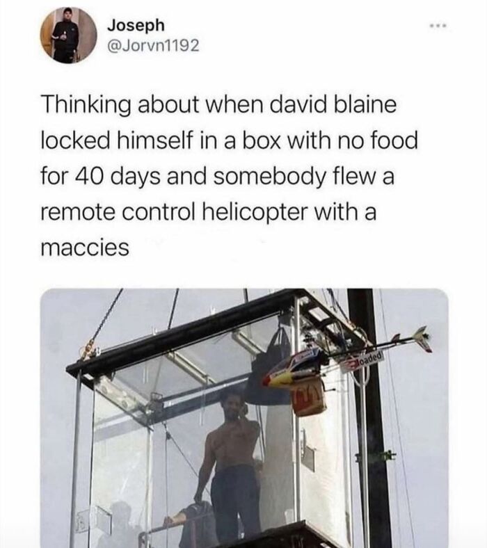 Funny random meme showing a man locked in a glass box with a remote control helicopter delivering food.
