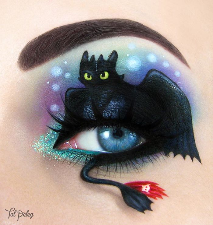 Eye makeup featuring a detailed black dragon design with vibrant colors and glitter showcasing incredible makeup looks by artists.