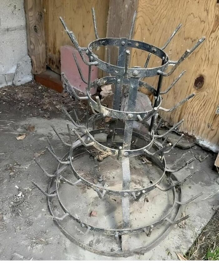 Rusty metal object with multiple hooks found in a home with hidden and forgotten haunted pasts.