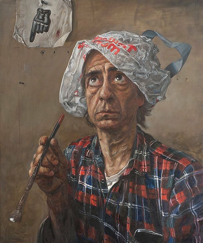 Man wearing plastic bag hat and plaid shirt, holding paintbrush, illustrating humorous layers and social tensions in art.