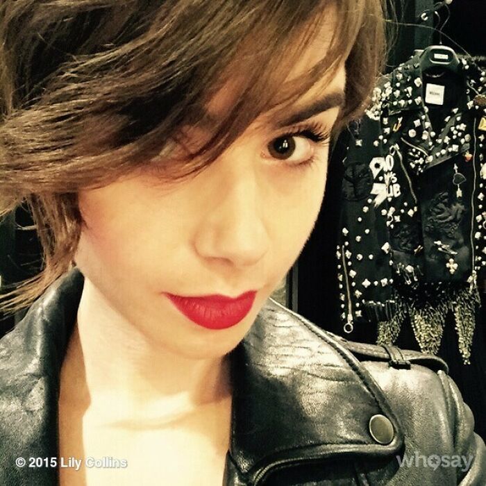 Young woman wearing red lipstick and leather jacket, posing for Instagram posts celebrities shared way back in the day.