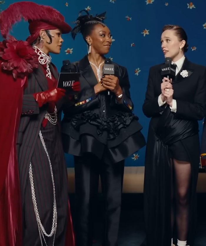 Aimee Lou Wood speaking at a Vogue event, addressing co-star Walton Goggins after his interview. Aimee Lou Wood speaking at a Vogue event, addressing co-star Walton Goggins after his interview.