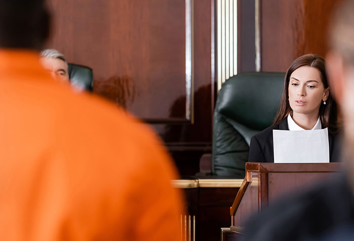 Female judge in courtroom reviewing documents during a major twist in Diddy case with alleged victim set to testify disappearing