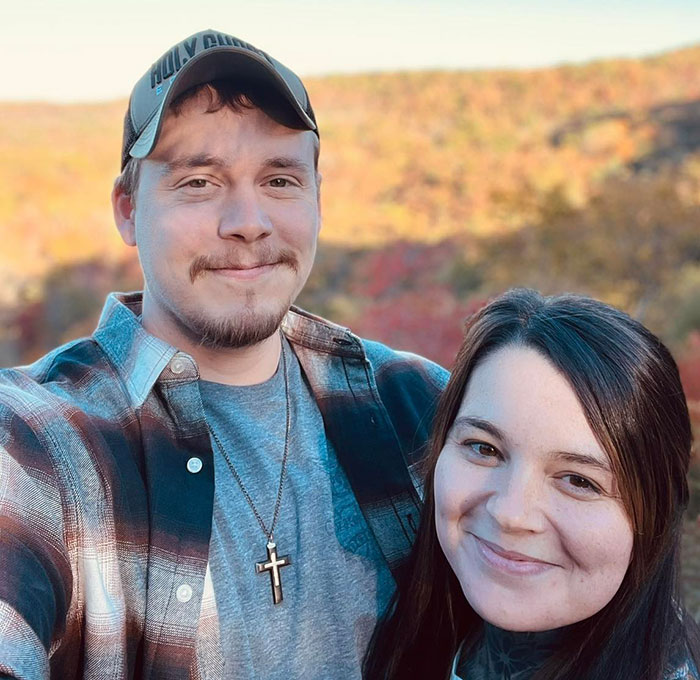 Couple smiling outdoors with fall foliage, symbolizing hope and faith related to Hand Of God in ultrasound prayer story.