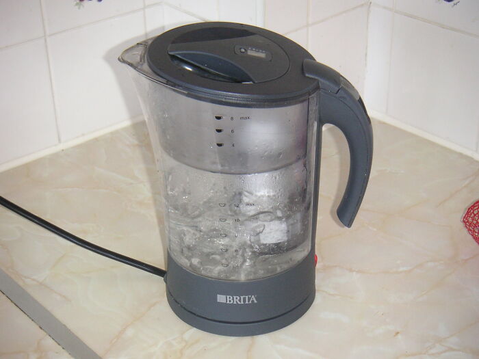 Electric Brita water kettle boiling water on kitchen counter representing excessive laziness concept.